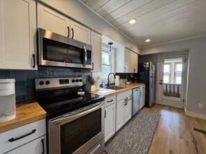 Fridge, microwave, oven, stovetop - Firefly Cottages on Bass Lake | Sandy Frontage, Dock, Kayaks, Near Downtown TC (Traverse City)
