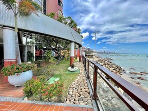 A waterfront promenade with a covered seating area, a view of the sea, and a city skyline in the background. - Apart-hotel Iate Plaza, Vista Completa da Orla de Fortaleza (Fortaleza)