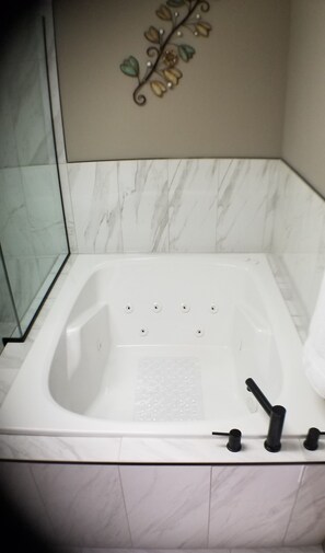 Jetted tub, hair dryer, towels, soap