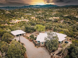 A residential area with multiple houses, a paved driveway, and surrounding greenery. - Near Santa Fe Plaza, Luxury Outdoor Space, Hot Tub (Santa Fe)