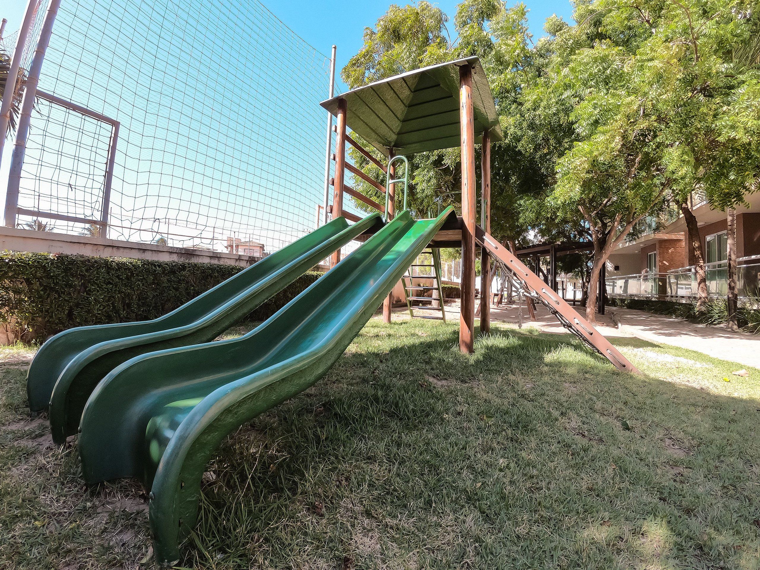 A playground with multiple slides and a climbing structure.