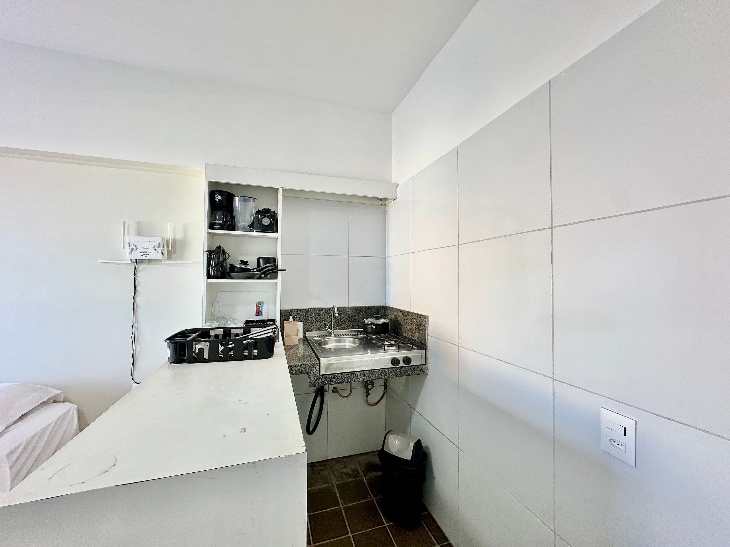 A compact kitchen with a gas stove, a sink, and a countertop.