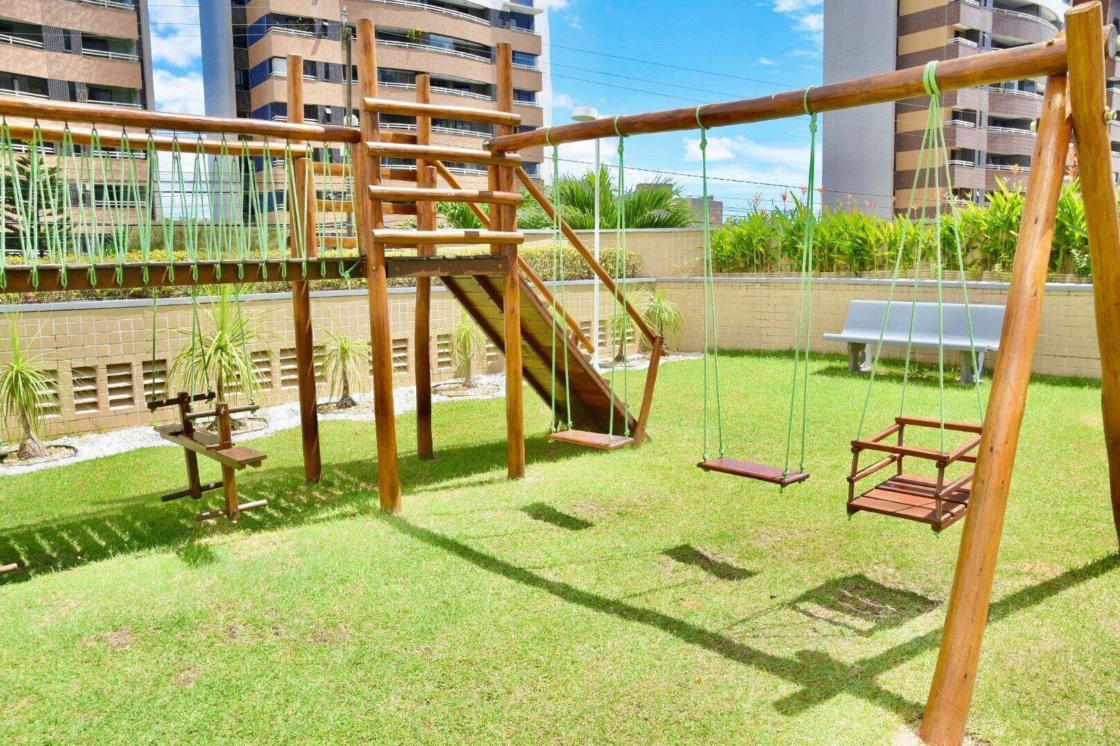 A playground with swings and a climbing structure.