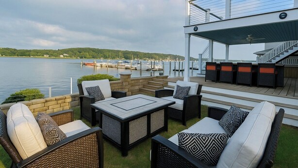 An outdoor patio with wicker furniture, a table, and a view of the water and dock. - 2 Waterfront Houses |Jacuzzi |Dock For Boat|Groups (New Haven)