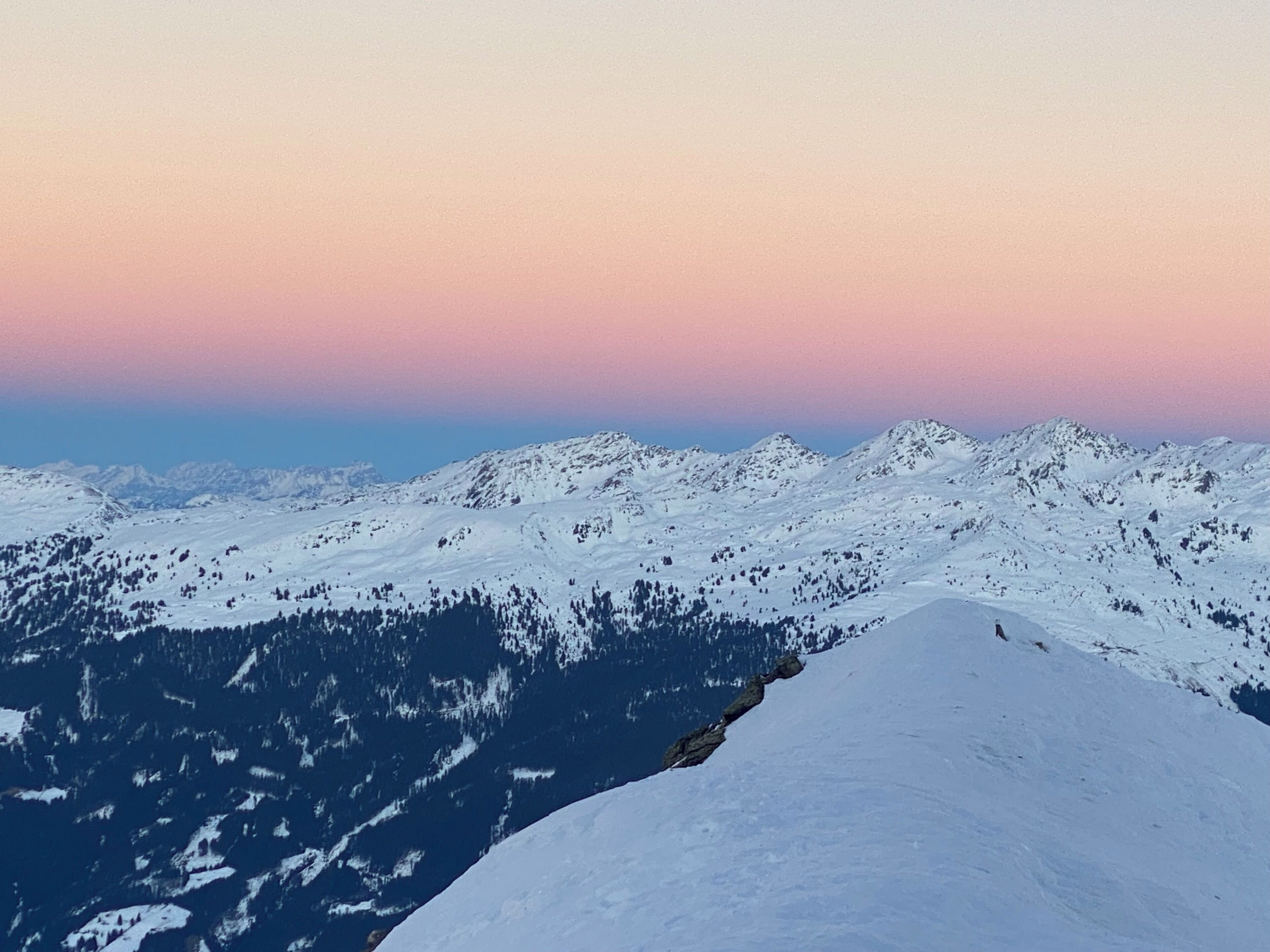 A snow-covered mountain range with a clear sky.