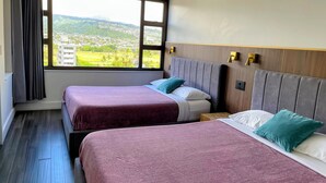 A hotel room with two beds, a large window with a view of a cityscape, and a wooden headboard. - Waikiki Banyan Pineapple Suite with AC & Free Parking (Honolulu)