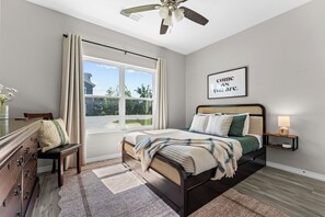 A bedroom with a bed, a nightstand, a dresser, a window, and a ceiling fan. - Pool Steps Away! Perfect for Families! Walk-in! (Branson)