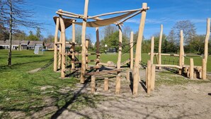 A wooden play structure in a park with a clear sky. - Vacation home, Zeeland, Holland, North Sea, Starnd, WLAN, family-friendly park (Bruinisse)