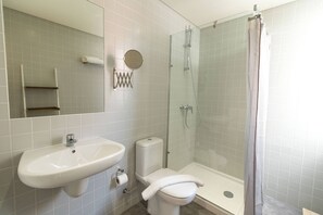 Ein Badezimmer mit Waschbecken, Toilette und Duschkabine.