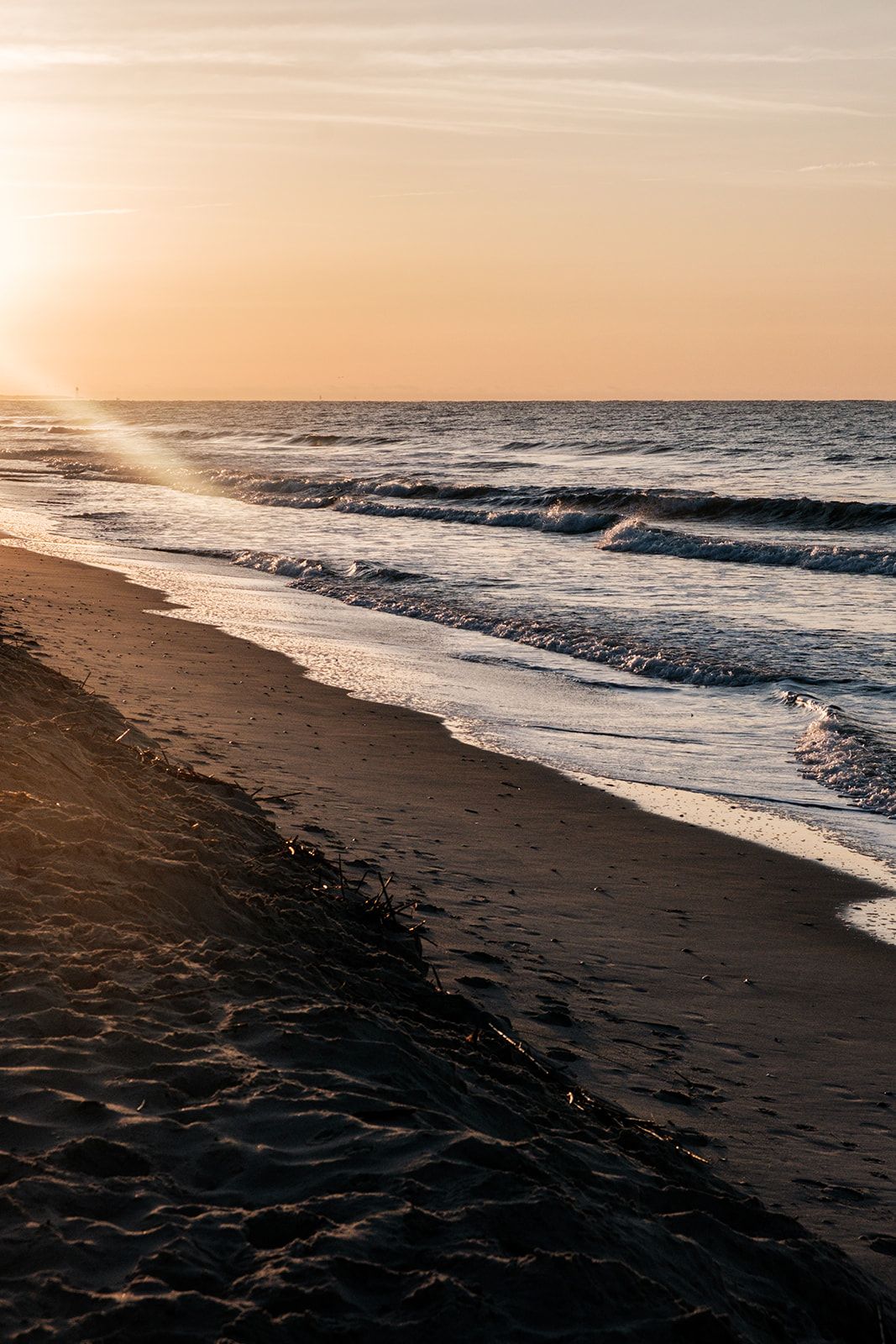 Golden sunset strolls along a peaceful beachfront shore