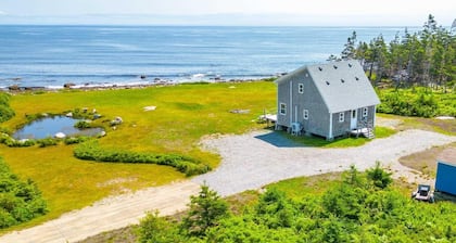 Cozy, tranquil waterfront retreat with a stunning oceanfront view in the pines.