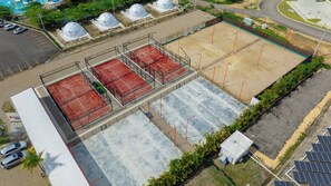 A rooftop parking area with solar panels, a swimming pool, and dome-shaped structures. - Prime Apartment With Fast Internet & Washer in SOV (Sosúa)