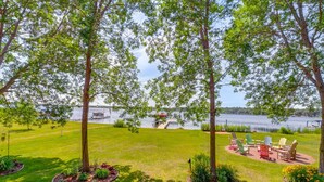 Une zone herbeuse avec des arbres et une jetée au bord d’un lac.