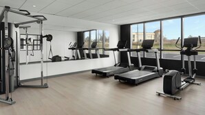 A gym with treadmills, elliptical machines, and weightlifting equipment. - StudioRes by Marriott Louisville East (Louisville)