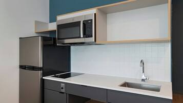 Full-size fridge, microwave, stovetop, freezer