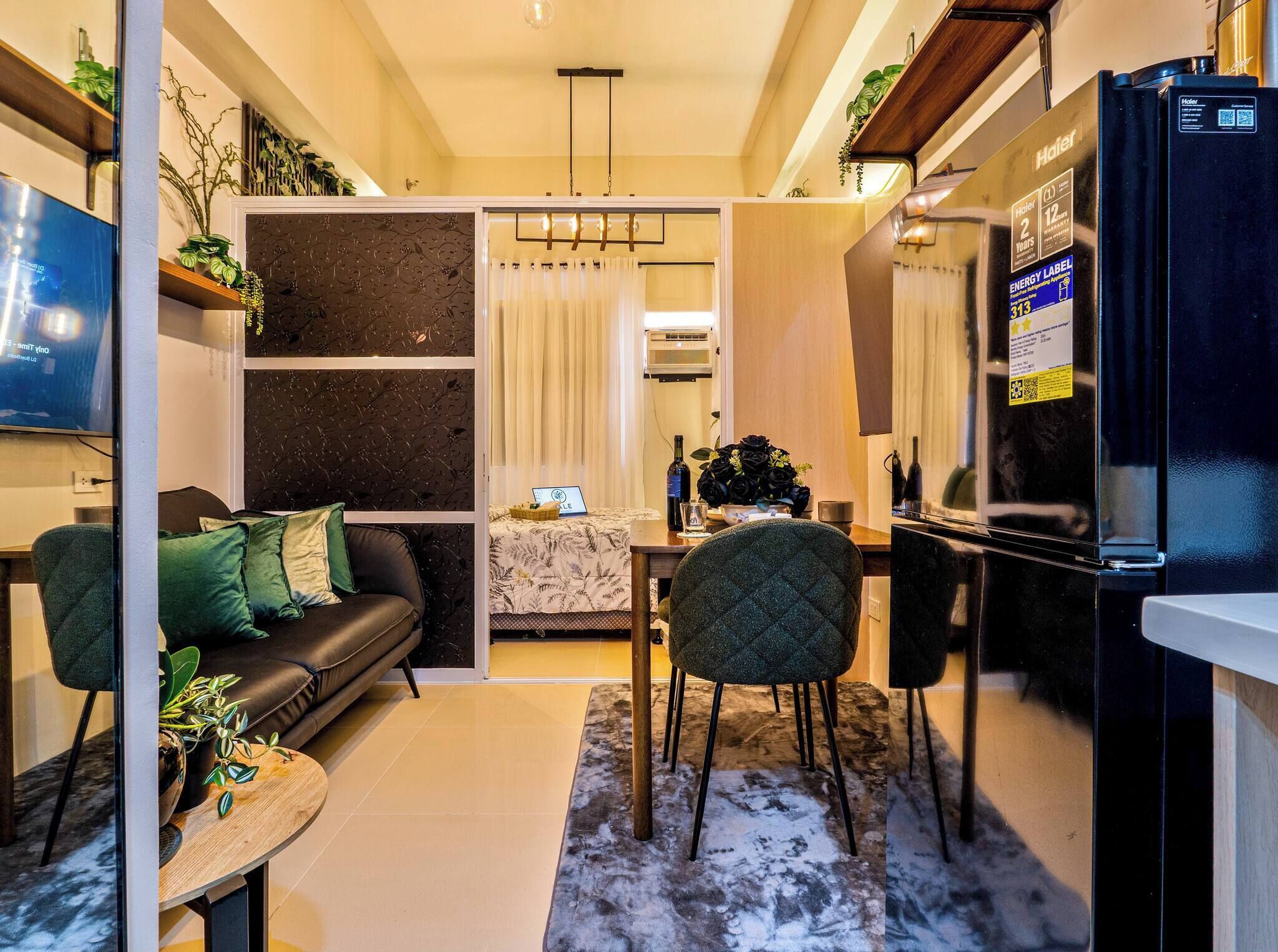 A modern living room with a sofa, coffee table, and a dining area with chairs and a table.
