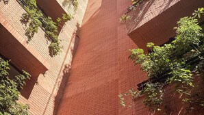 A brick building with a steep, narrow staircase. - EMA Condesa (Mexico City)