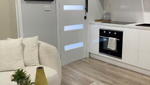A modern kitchen with a built-in oven, a countertop, and a wall-mounted stove.