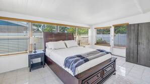 A bedroom with a large bed, a nightstand, a dresser, and a wardrobe. - Relaxing Stay Minutes from the beach (Seminole)