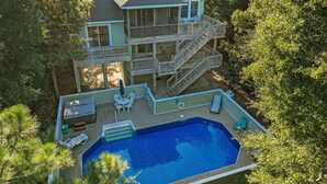 A multi-story house with a swimming pool, outdoor furniture, and a deck. - 5BR Outer Banks Retreat ✦ Pool ✦ Spa ✦ Private Beach Access Prkg ✦ Dog-Friendly (Southern Shores)