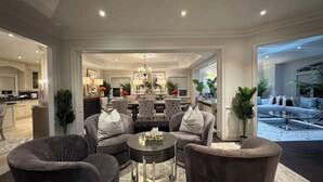 A spacious living room with a dining area, a kitchen, and a bedroom with a large window. - Richmond Hill Mansion | Ultimate Executive Retreat (Richmond Hill)