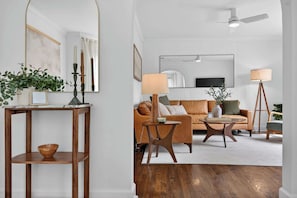 A living room with a sofa, coffee table, and a TV. - Modern 10th St Retreat: Downtown & Hyde Park (Boise)