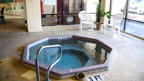 A hot tub with a metal ladder, surrounded by chairs and a mural on the wall. - Spacious 3-bedroom condo in peaceful Murrells Inlet with AC / CAT #1 (Murrells Inlet)
