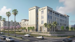 A modern hotel building with a prominent logo, multiple floors, and a parking area with cars. - Element by Marriott San Diego Chula Vista (Chula Vista)