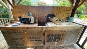 A wooden bar area with a microwave, coffee maker, and a sink. - KAY TI CANNELLE (Le Diamant)
