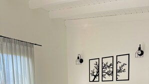 A neatly made bed with towels, a headboard, and wall art. - Botanical Study 1 (San Carlos de Bariloche)