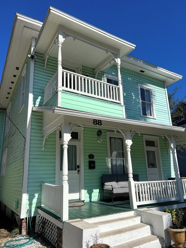 A two-story house with a porch, a front door, and a number '88' on the wall. - Enjoy our newly renovated beautiful Victorian home in downtown St Augustine. (St. Augustine)
