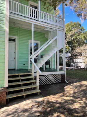 A two-story house with a porch, a staircase, and a front door. - Enjoy our newly renovated beautiful Victorian home in downtown St Augustine. (St. Augustine)