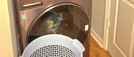 A compact, wall-mounted washing machine with a control panel and a dryer below.