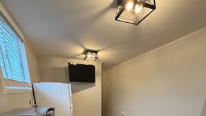 A compact kitchen with a refrigerator, microwave, and coffee maker.