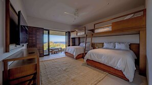 A bedroom with bunk beds, a desk, a television, and a view of the outdoors. - Luxury Iyari Villa Inside Punta Mita Ocean View (Corral del Risco)