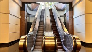 A pair of escalators in a modern building with a clean, geometric design. - Penthouse Loft LargeTerrace2-bedroom Kitchen Seaside  HPU&Cruise  8 person (Honolulu)
