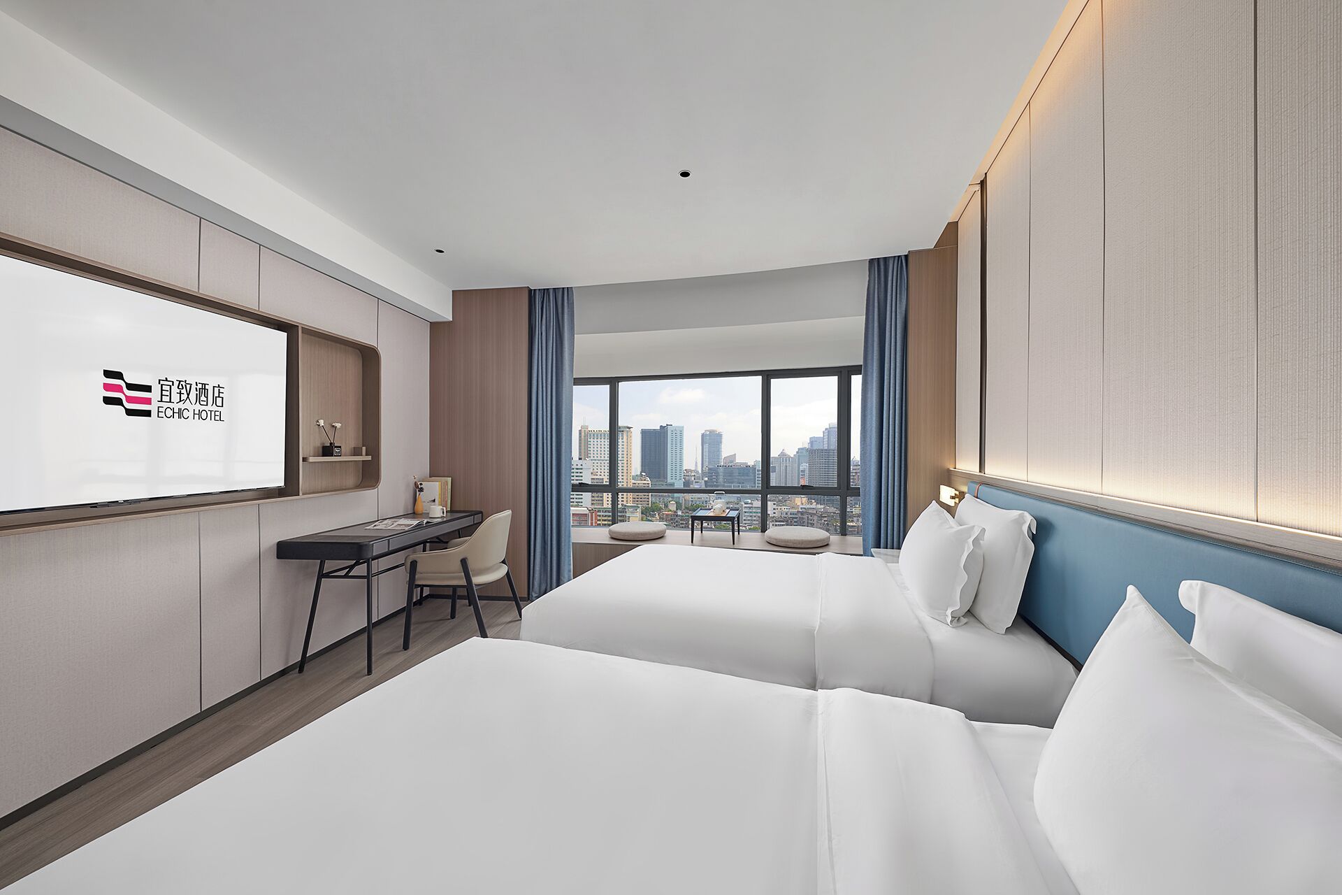 A hotel room with a large bed, a desk, and a view of the cityscape.