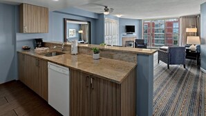 A modern kitchen with a dishwasher, a sink, and a countertop with a plant. - Victoria | Group Harbor Retreat | Pool + Harbor | 2BR (Victoria)