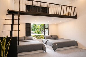 A modern bedroom with two beds, a lofted sleeping area, and a view of greenery outside. - Hoan Kiem Lake View / Balcony / 3Q Beds / 6 Pax (Hà Nội)