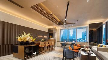 A modern living room with a dining area, large windows, and a city view.