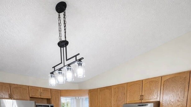 A modern kitchen with wooden cabinets, stainless steel appliances, and a central island.