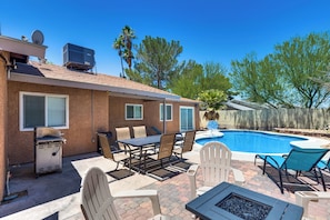 A backyard with a pool, patio furniture, and a grill. - Lux - Mins To Strip, Allegiant Stadium and The Sphere (Las Vegas)
