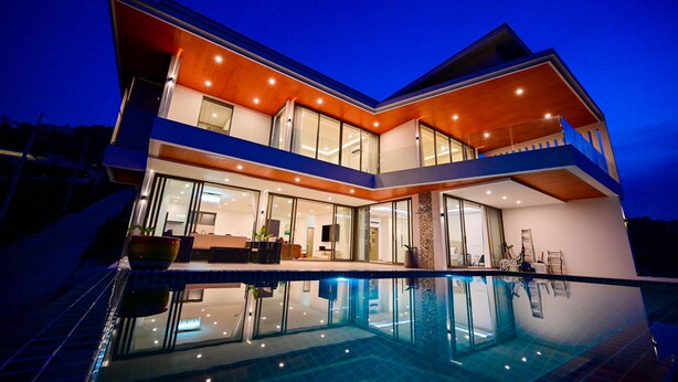 A modern multi-story house with a swimming pool in the foreground. - Ocean Skyline Villa-Luxury (Koh Samui)