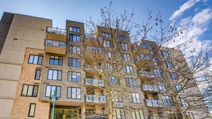 A multi-story building with a sign reading 'Legacy on Mara Lake.' - 3 Bed 3 bath Penthouse on Mara, Pool, Gym, Steam room (Sicamous)