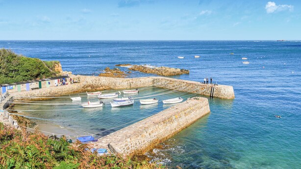 A coastal harbor with boats docked, stone walls, and a clear blue sky. - Cozy home in Saint-Christophe-du-Foc with WiFi (Saint-Christophe-du-Foc)