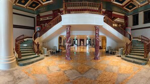 A grand lobby with marble floors, a central staircase, and classical columns. - Napas.manor (Wujie)