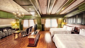 A hotel room with a sofa, two beds, a TV, a chandelier, and a wooden floor. - Napas.manor (Wujie)