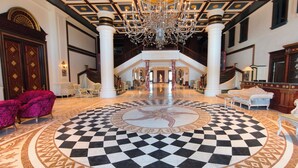 A grand lobby with a checkered floor, a chandelier, and classical architecture. - Napas.manor (Wujie)