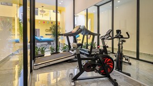 A gym with exercise equipment, a treadmill, and a stationary bike. - Corner Centre Villa Hoi An (Da Nang)