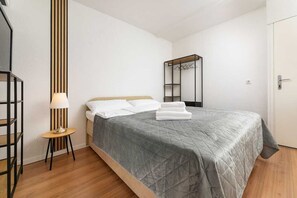 A neatly arranged bedroom with a bed, a bedside table with a lamp, and a wardrobe. - Apartment Maria Zestilac (Žestilac)
